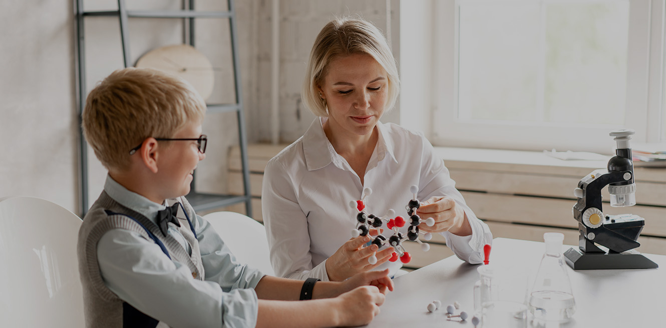 Female science tutor in San Jose studying chemistry with student